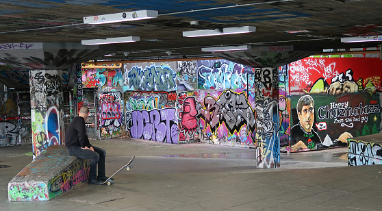 Public skateboard BMX park space beneath Queen Elizabeth Hall, Southbank of river Thames. Graffiti and skaters. Winters day. London, United Kingdom, December 21, 2019