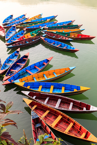 Multi-colored wooden boats on the Phewa lake, Pokhara, Nepal