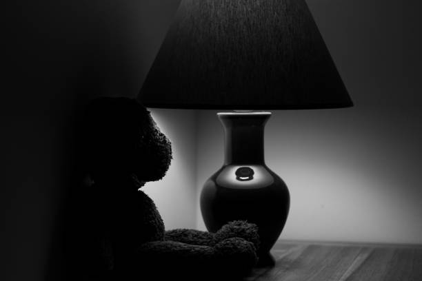 bedside lamp in the dark Reflected from the mirror of the hotel room