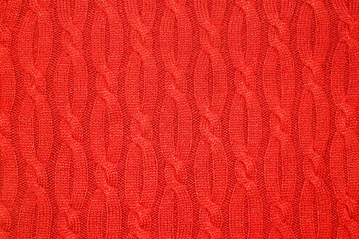 Warm knitted woolen background, red texture