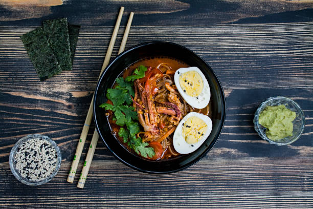 istock Japanese ramen with seafood, herbs and pickled eggs on a dark background. 1195280687