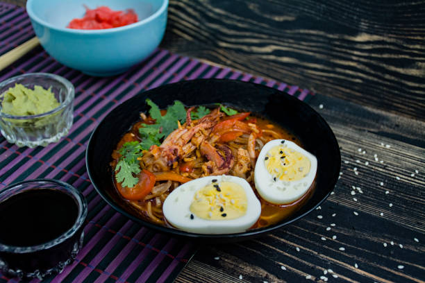 istock Japanese ramen with seafood, herbs and pickled eggs on a dark background. 1195280714