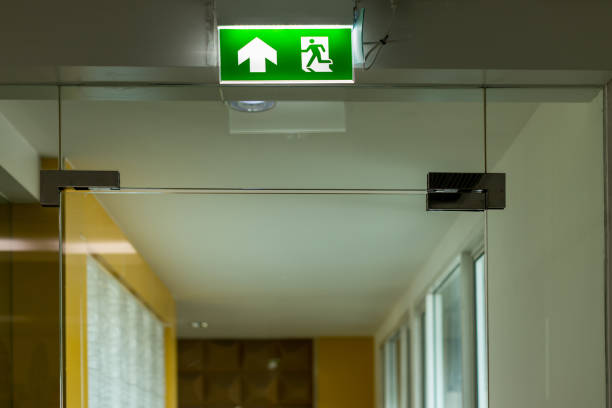 istock Green emergency exit sign showing the way to escape.Fire exit in the building 1195282237