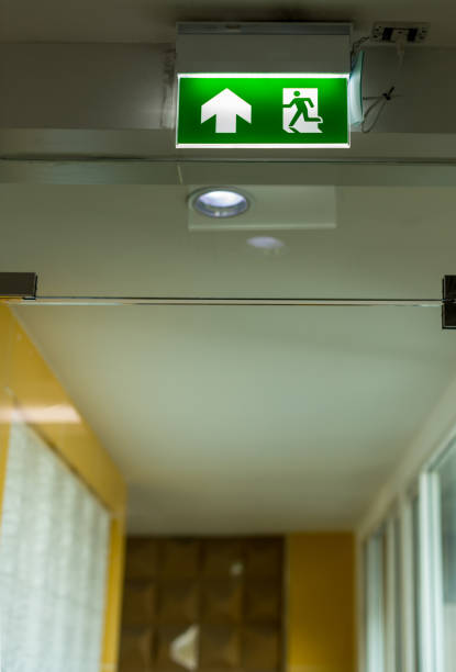 istock Green emergency exit sign showing the way to escape.Fire exit in the building 1195282246