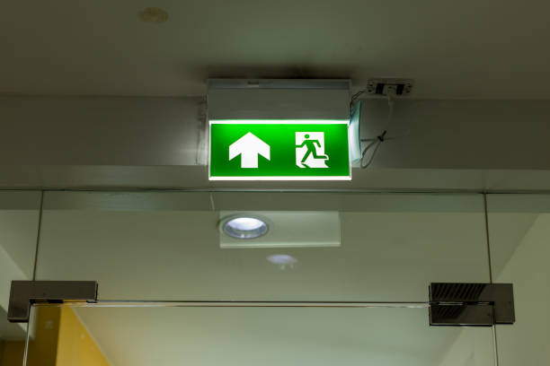 istock Green emergency exit sign showing the way to escape.Fire exit in the building 1195282250