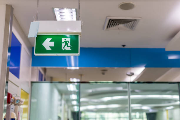 istock Green emergency exit sign showing the way to escape.Fire exit in the building 1195282281