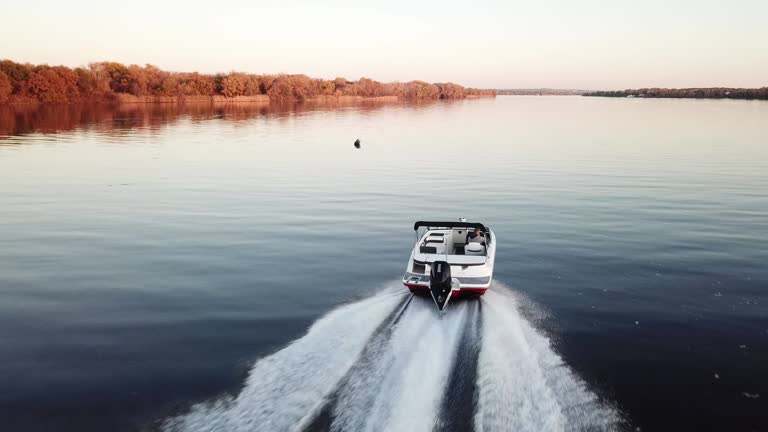 motor boat floating on the river at sunset