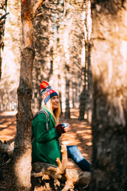 istock Cute Woman is Drinking Coffee in the Forest 1195291690