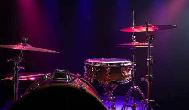 istock Drums and drum set. Beautiful blue and red background, with rays of light. Beautiful special effects of smoke and lighting. Musical instrument. Close-up photo. 1195291765
