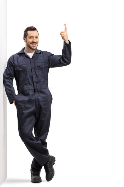 istock Worker in an overall uniform pointing up 1195293939