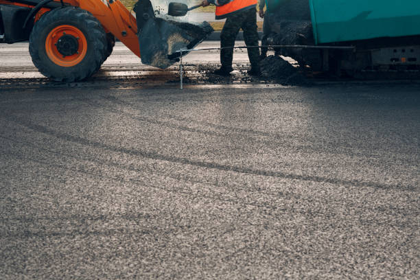 istock Asphalt paving. Paver man and road roller. New road construction. 1195294139