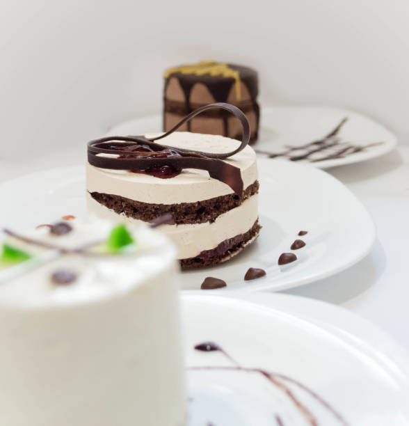 istock Delicious cakes on plates close up 1195294151