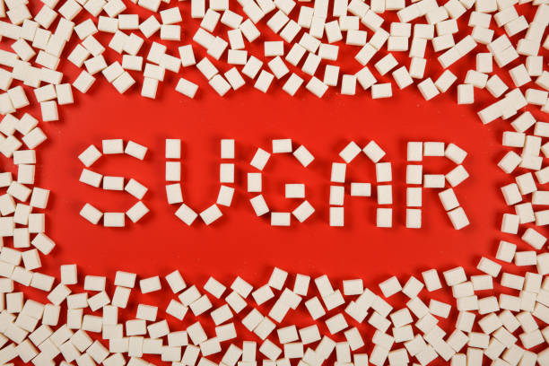 istock text sugar with frame made of sugar cubes on red background. 1195304178