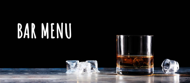istock Glass of whiskey with ice on the table 1195307065