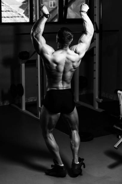 istock Handsome Muscular Man Flexing Muscles In Gym 1195310075