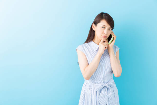 istock asian woman who talks on the telephone,think 1195317343
