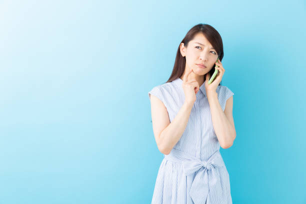 istock asian woman who talks on the telephone,think 1195317393