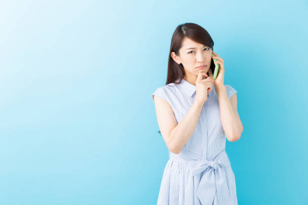 istock asian woman who talks on the telephone,think 1195317450