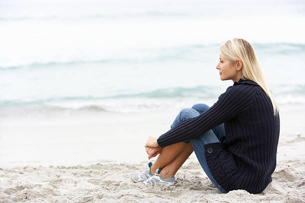 istock Woman Sitting On Winter Beach 119532216