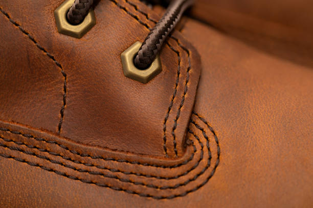 Brand new brown winter boots on gray background