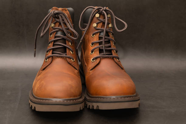 Brand new brown winter boots on gray background