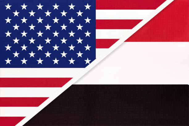 istock USA vs Yemen national flag from textile. Relationship between two american and asian countries. 1195359077