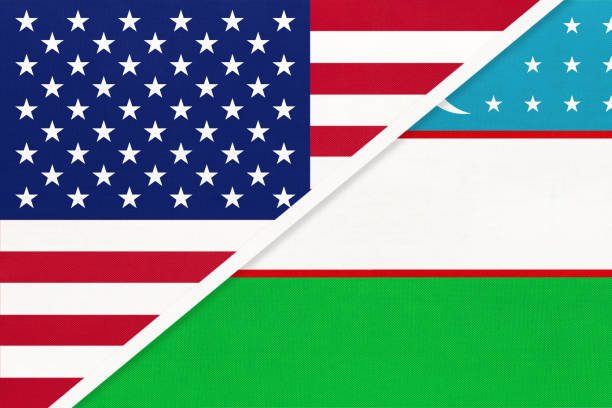istock USA vs Uzbekistan national flag from textile. Relationship between two american and asian countries. 1195359083