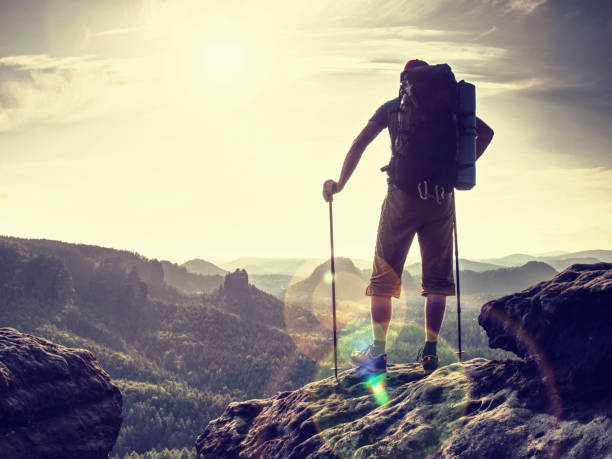 istock Man with backpack and hiking poles. Danger place a 1195365467