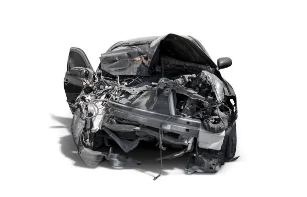 carcass of crashed black car in front side isolated on white background with clipping path, Car insurance and accident concept