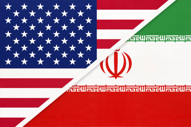 istock USA vs Islamic Republic of Iran national flag from textile. Relationship between two american and asian countries. 1195366283