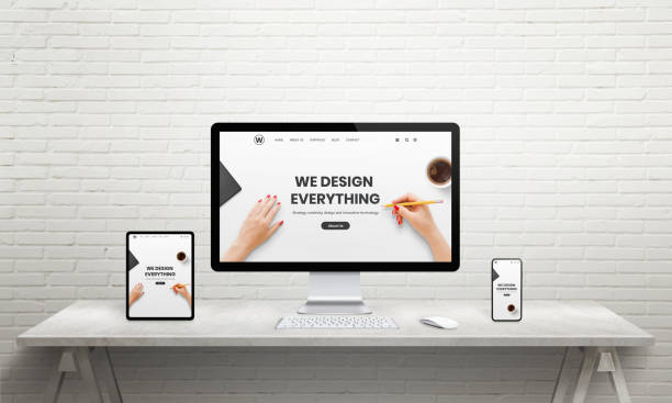 istock Designer desk with computer display, tablet and phone. Designer studio page on device displays. Resonsive web design concept 1195366425
