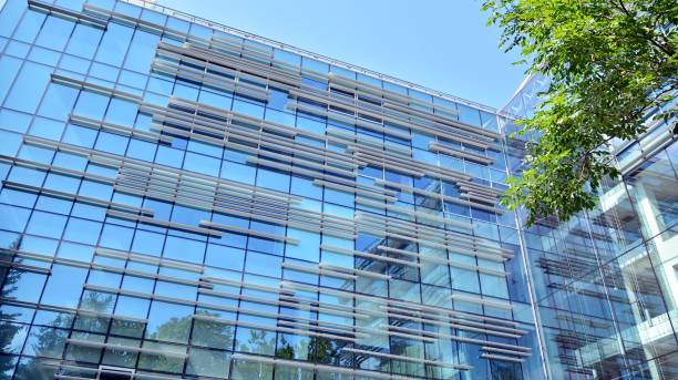 istock Modern office building with reflection in windows of building 1195369204