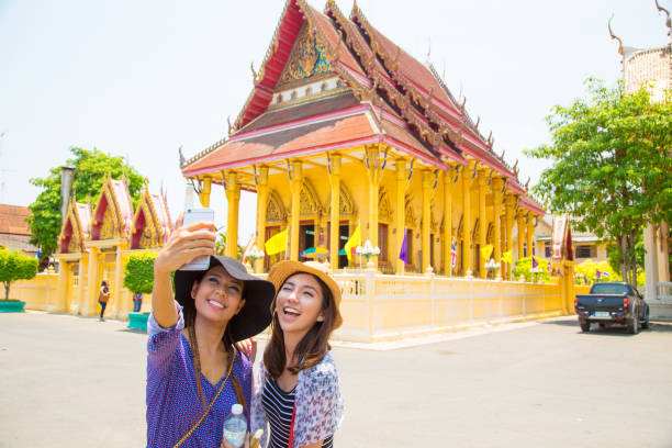 istock Two asian friends taking selfie 1195370474