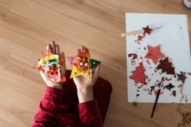 istock Child making christmas ornaments 1195371333
