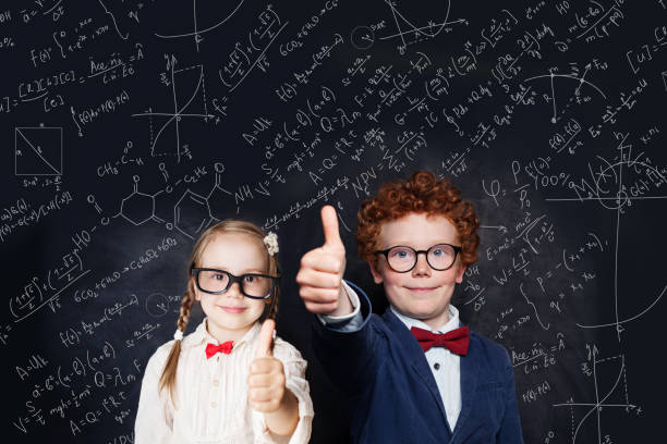 istock Smart children school student in glasses having fun on background with science and maths formulas 1195373607