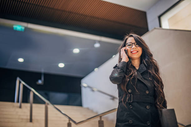 istock Cheerful woman is talking on phone 1195375385