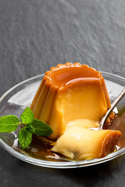 istock Creme caramel custard pudding on black stone background 1195376424