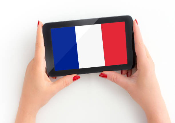 istock Woman holds her tablet with french Flag 1195376521