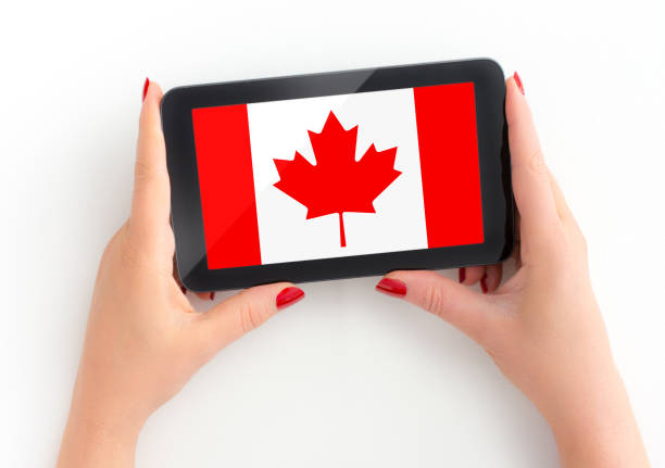 istock Woman holds her tablet with canadian Flag 1195376536