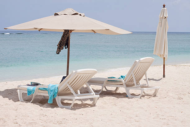 istock reclining chairs under beach umbrellas 119537724