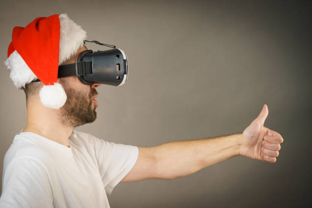 Man in virtual reality goggles and santa hat