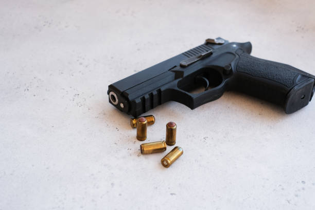 istock A handgun with bullets symbolizing gun rights while framed against the United States constitution. 1195379683