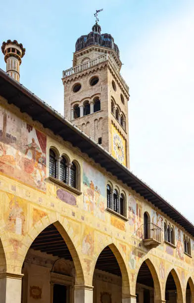 Conegliano, Italy, the facade with frescoes and the bell tower of the Cathedral
