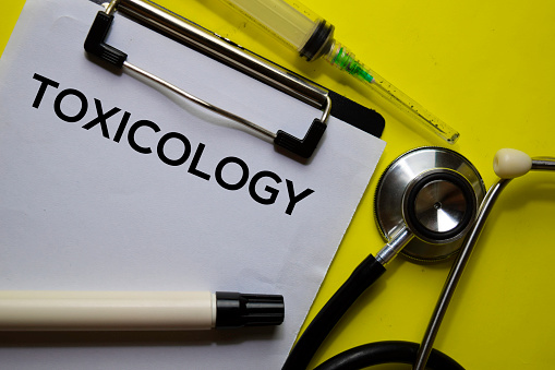 Toxicology on the Document with yellow background. Healthcare or Medical concept
