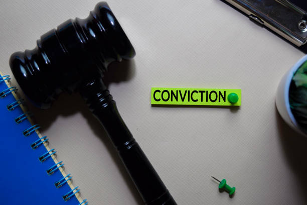 istock Conviction text on sticky notes and gavel isolated on office desk. Justice law concept 1195381583