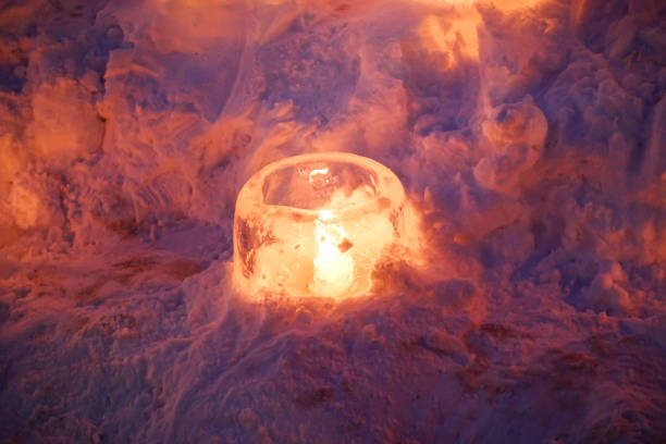 istock Candle light in ice and snow on Christmas day 1195381669