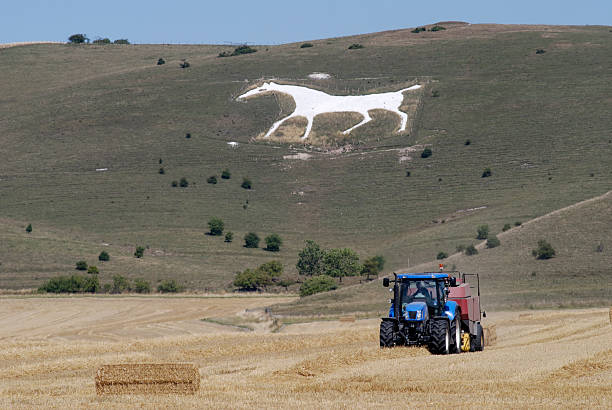 istock Tractor under White Chalk Horse. Wiltshire. England 119538175