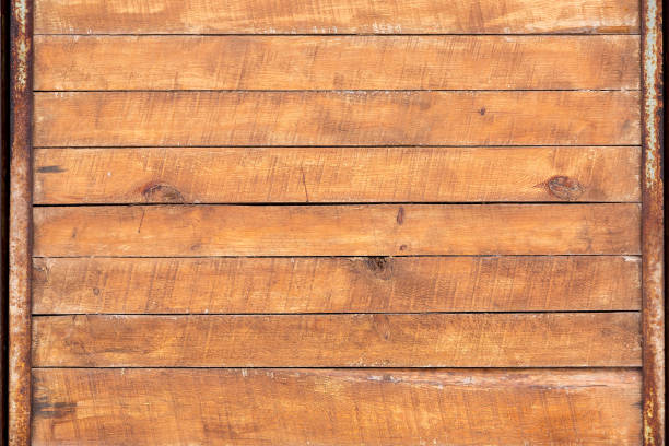 istock Brown boards with iron rusty frame, wooden floor texture top view. 1195383910