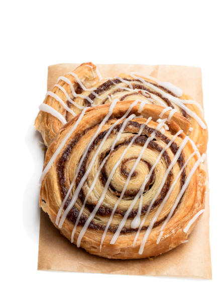 istock Freshly baked traditional cinnamon swirls isolated on white 1195385042