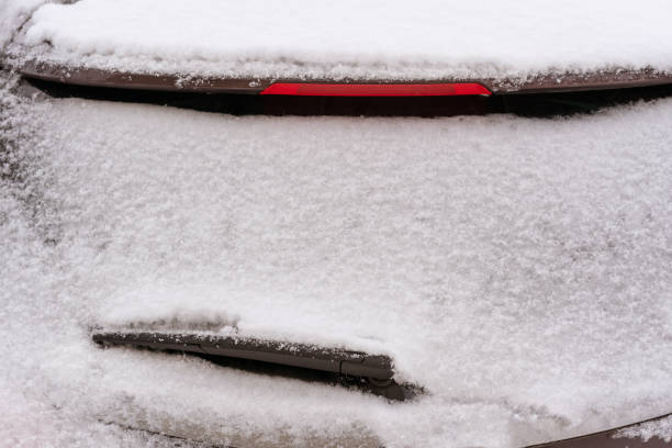 istock Car Rearview glass is covered with snow 1195385763